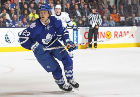 brooks in the hockey ring in action, trying to hit a score 